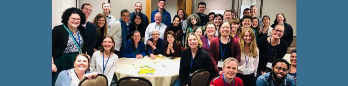 Large group of smiling people including diverse array of genders and ethnicities. All are wearing LSA conference badges.